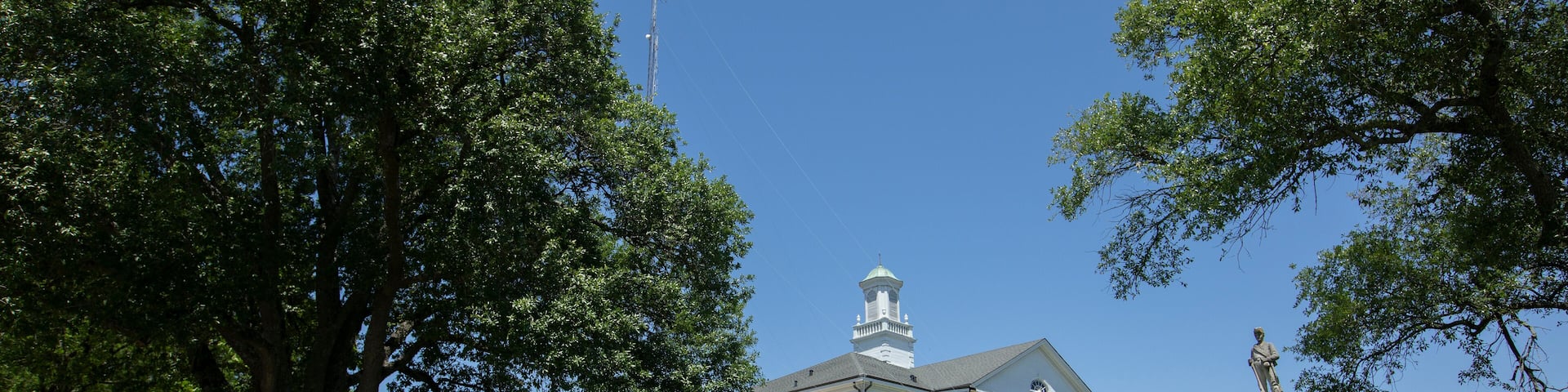 Tallulah, Louisiana, USA - April 23, 2024: Afternoon sun shines on the historic 1887 Madison Parish Courthouse of downtown Tallulah.