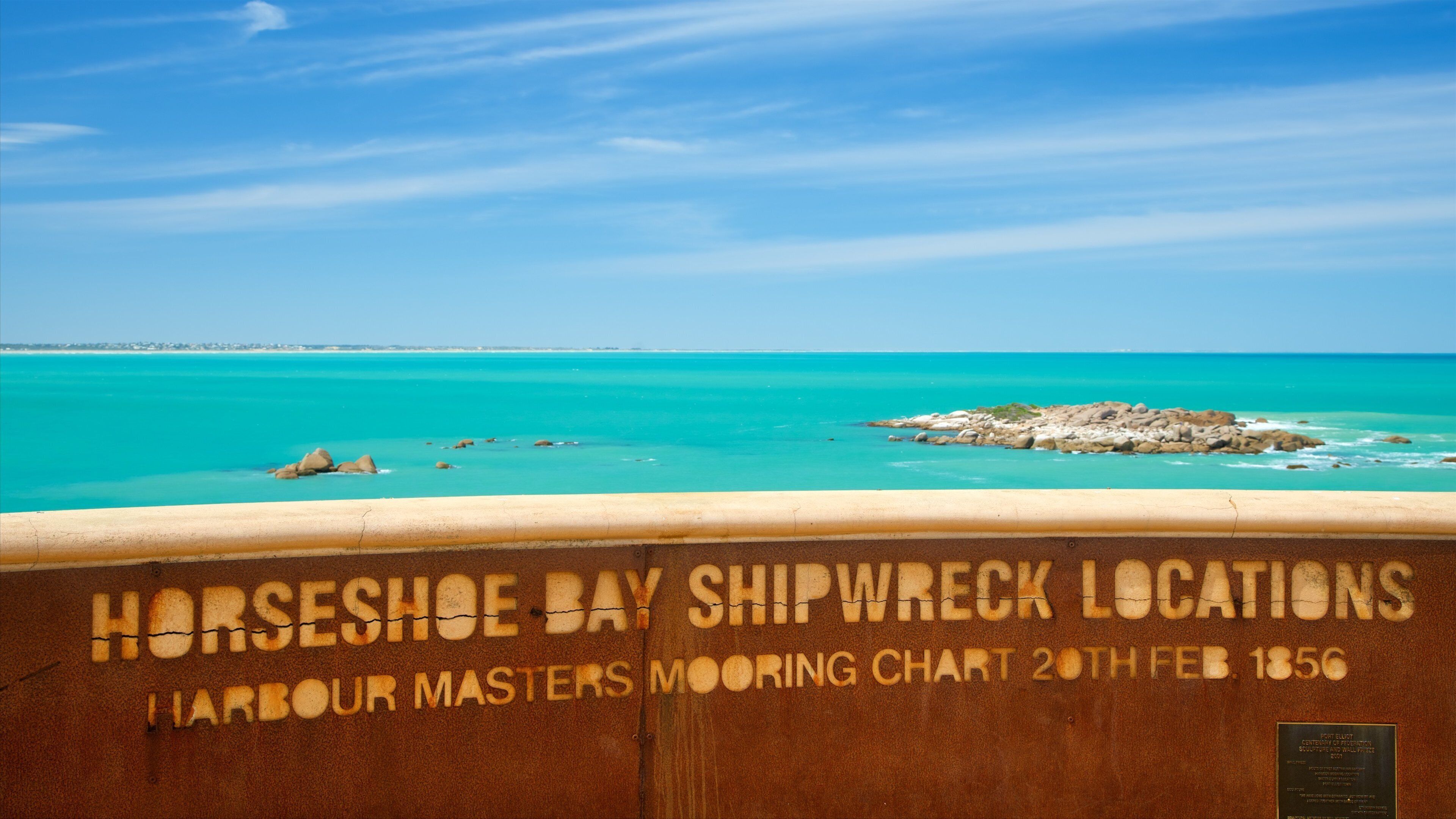 A shipwreck chart at Horseshoe Bay with turquoise waters and rocky outcrops.