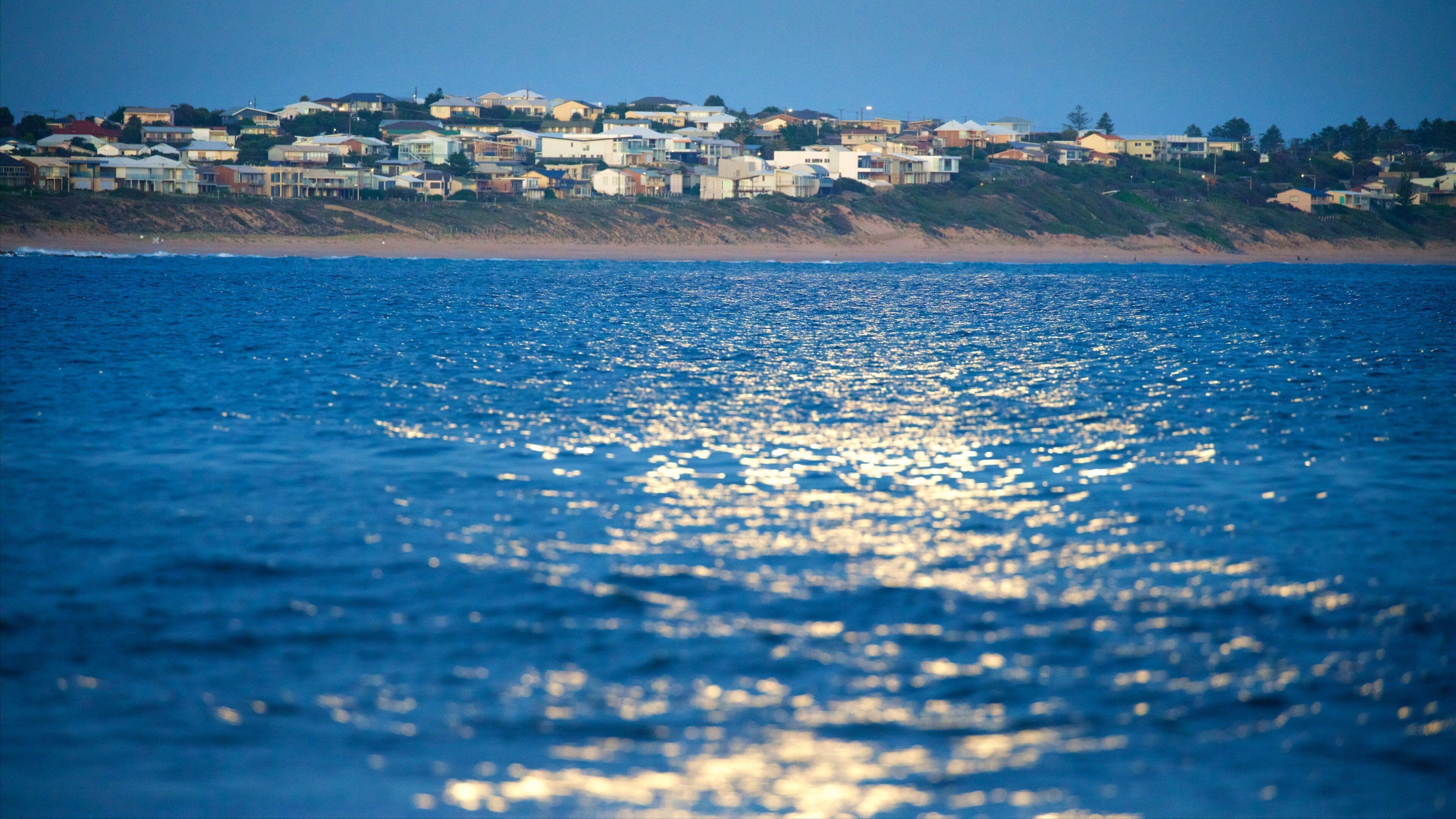 Victor Harbor showing waves, night scenes and a beach