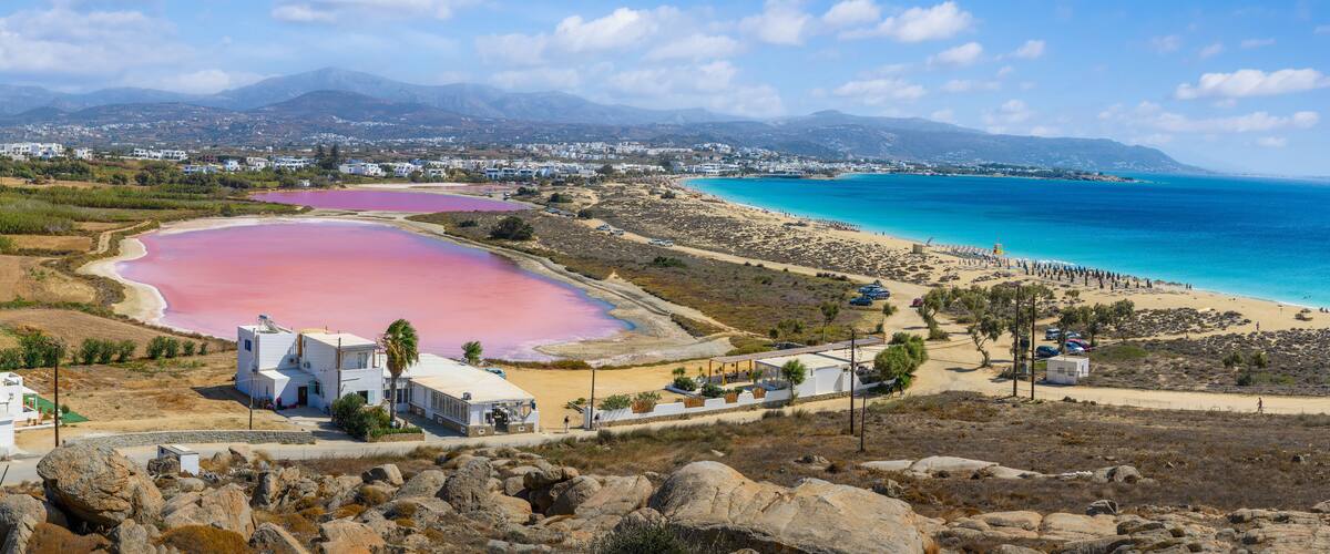 Landscape with Agios Prokopios beach and pink salt lake, Naxos island, Greece Cyclades