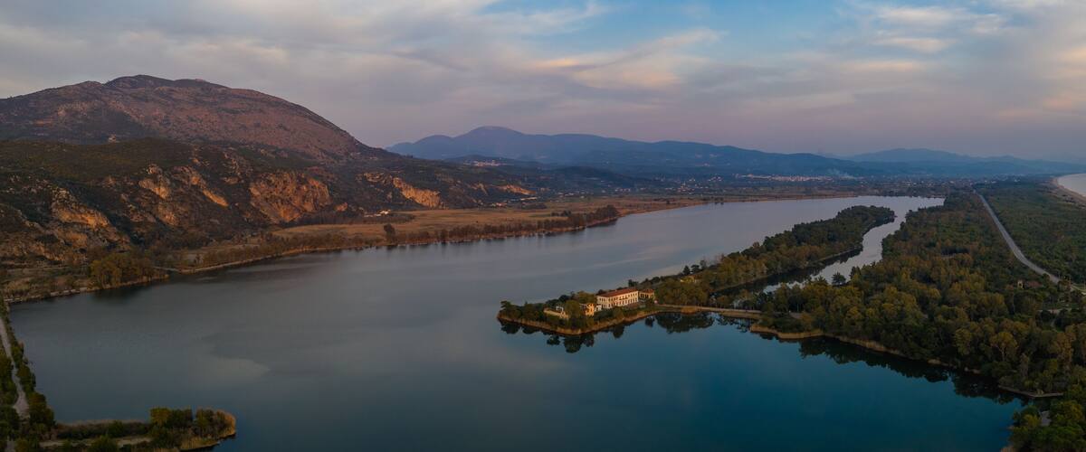 A lake surrounded by mountains and a coastal road.