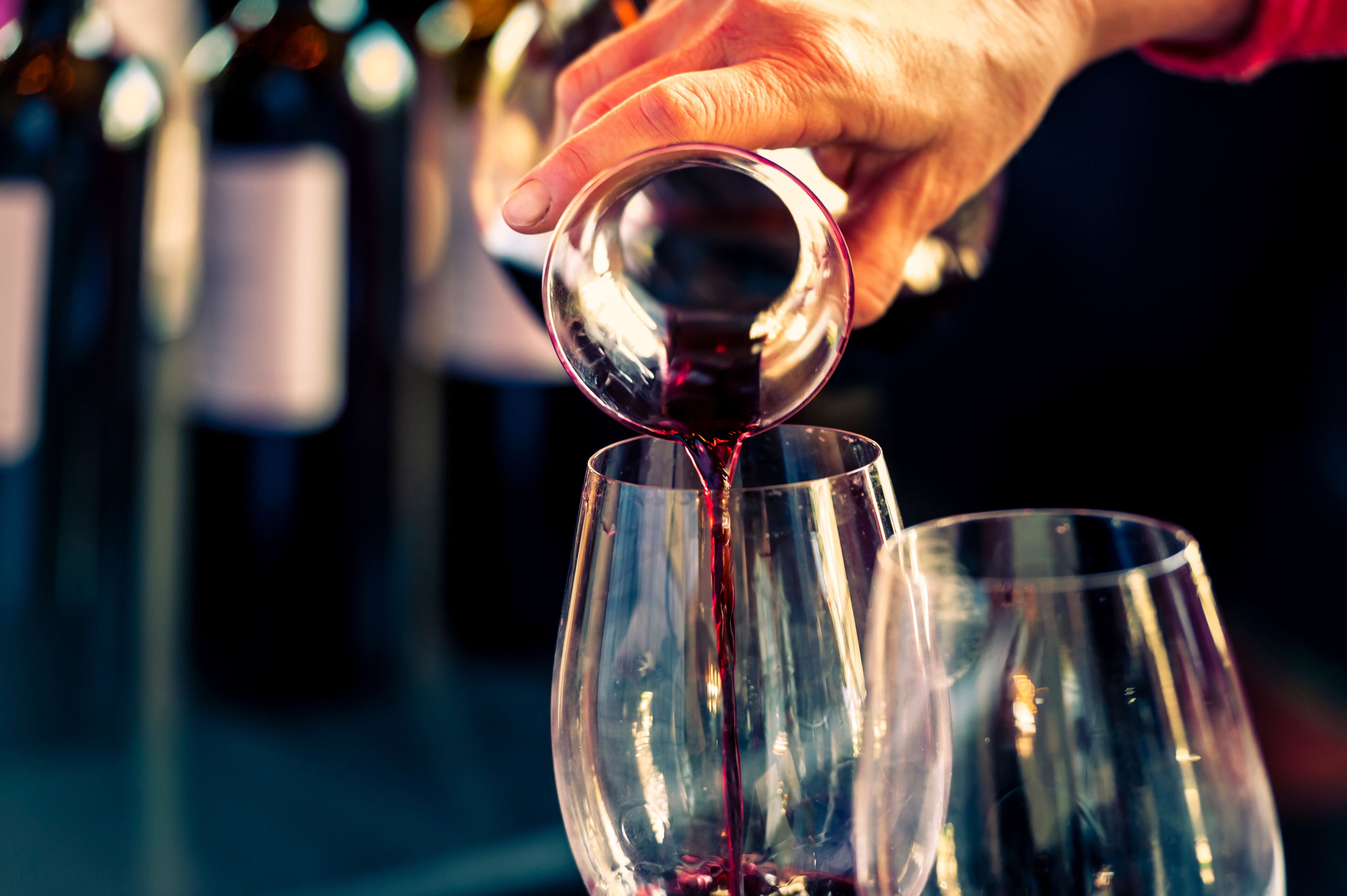 USA, Washington State, Walla Walla. Man pours red wine before tasting at a Walla Walla wine event.