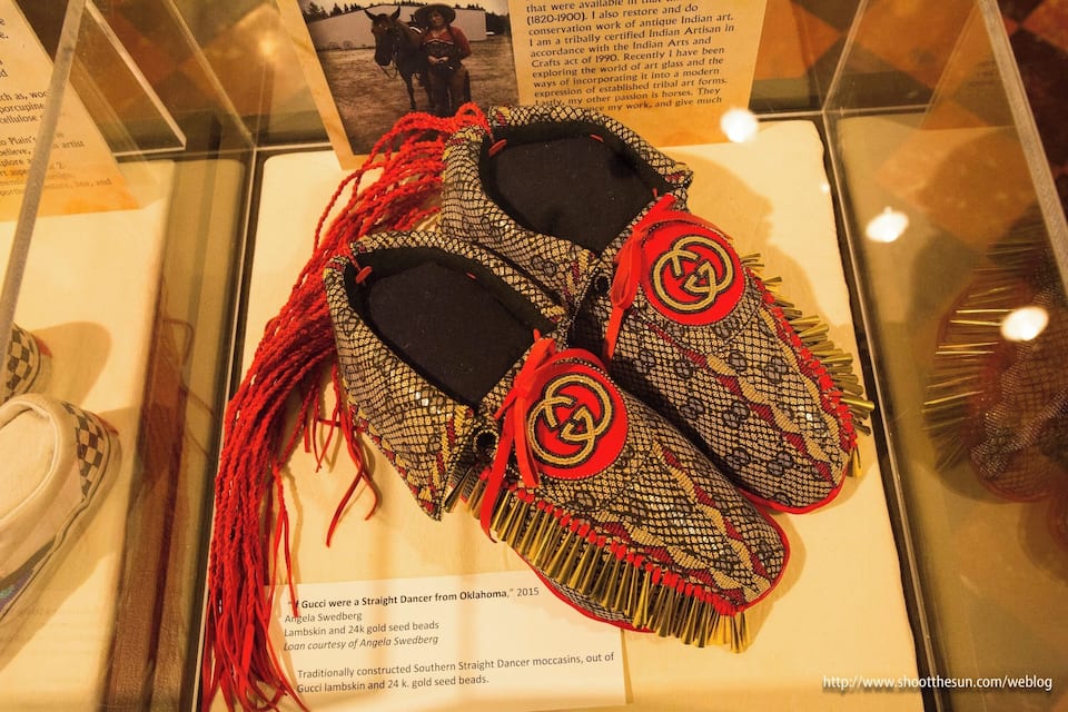Moccasins with red tassels and gold beadwork.