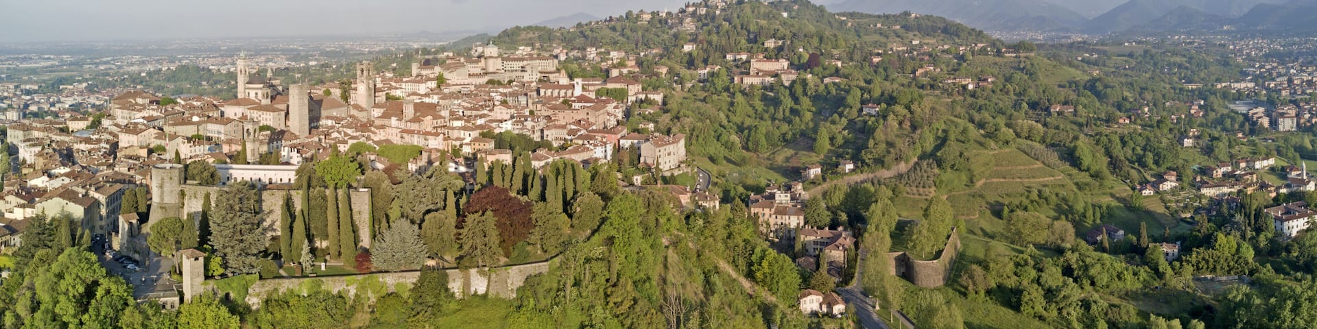 Drone aerial view of Bergamo - Old city. One of the beautiful city in Italy. Landscape on the city center, its historical buildings and towers during a wonderful blu day