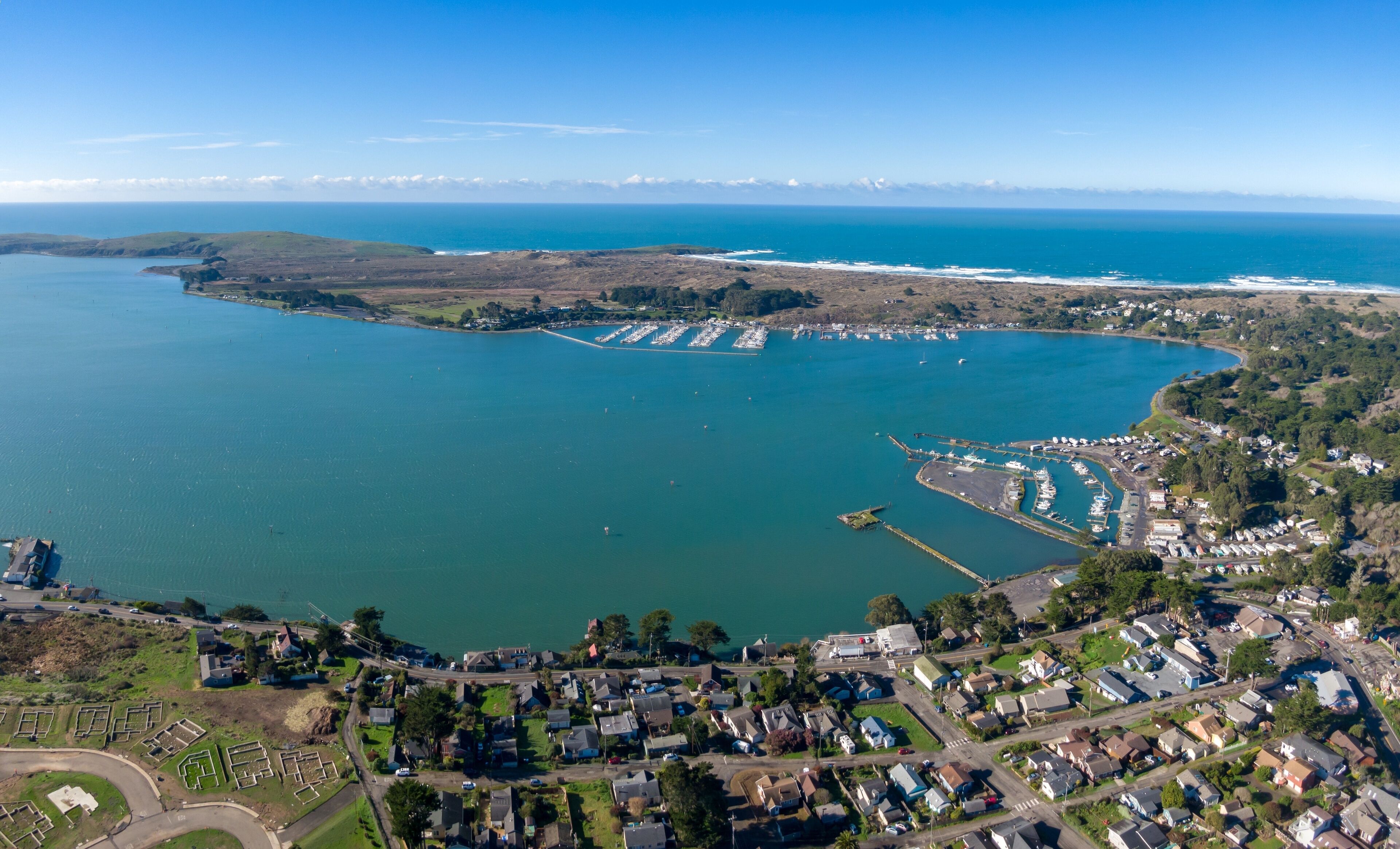 Aerial of ocean, township and marina in Bodega Bay, California, United States of America.