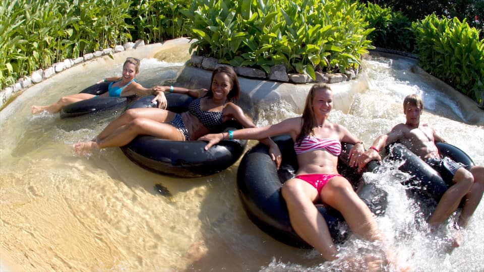 People on water tubes in a water park.