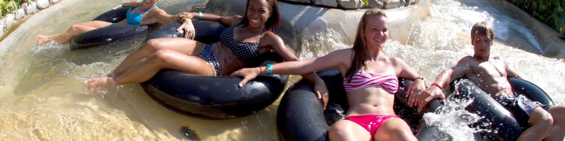 Schlitterbahn Waterpark which includes a pool and a waterpark as well as a small group of people