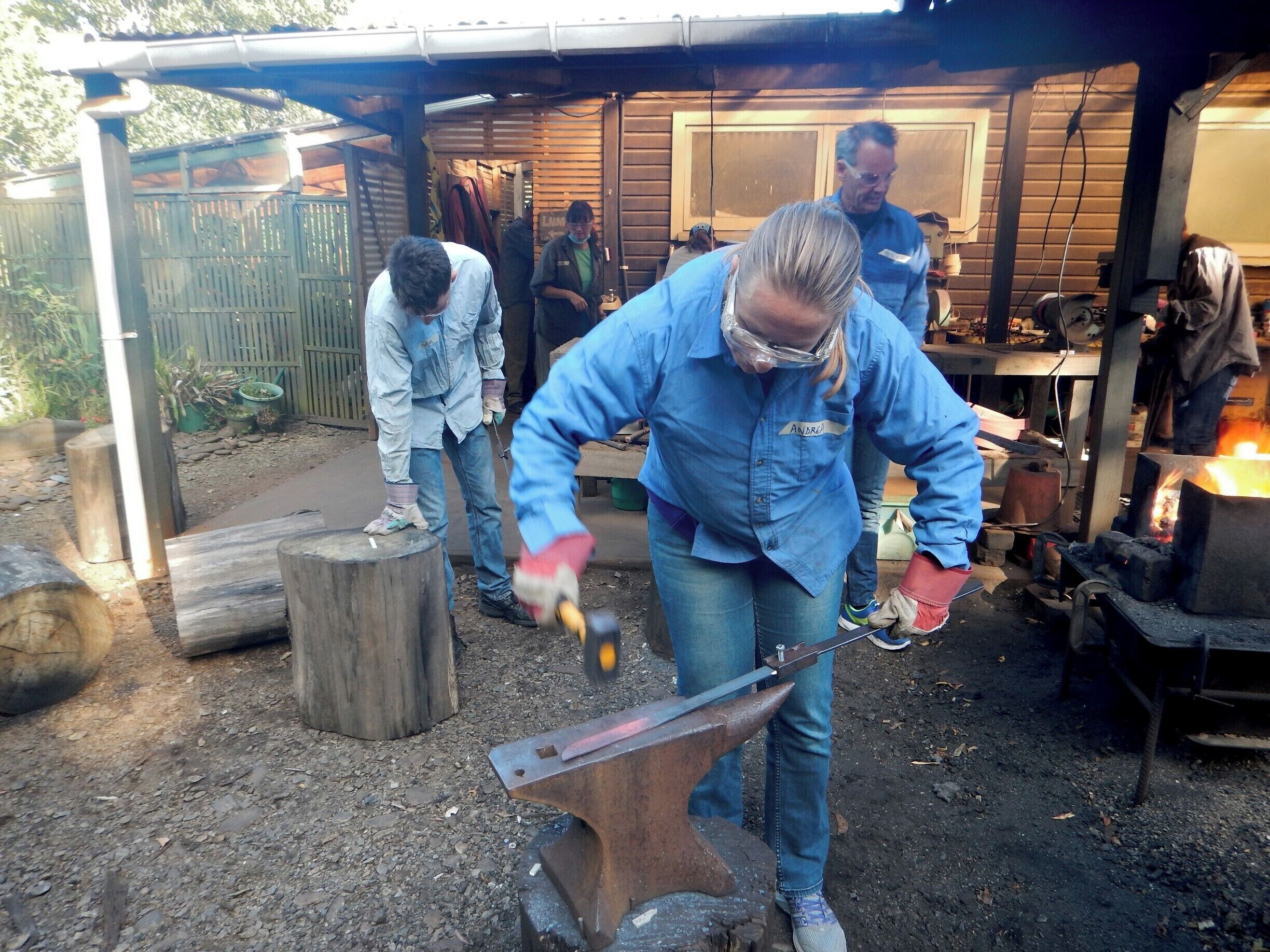 A blacksmith workshop with an anvil, tools, and a forge.