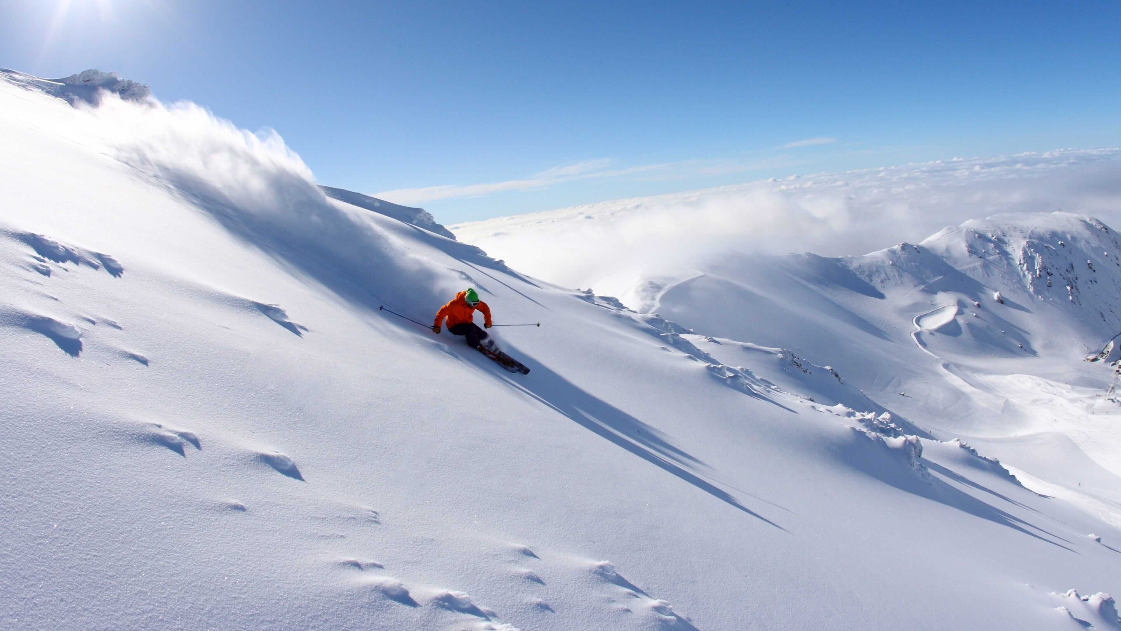 A skier on a snowy mountain slope.