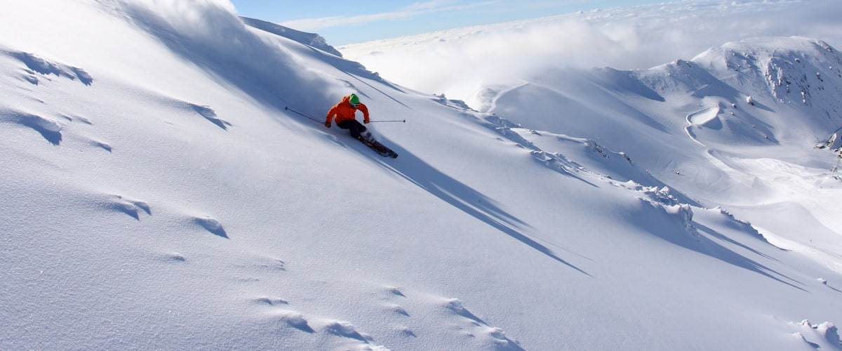 A skier on a snowy mountain slope.