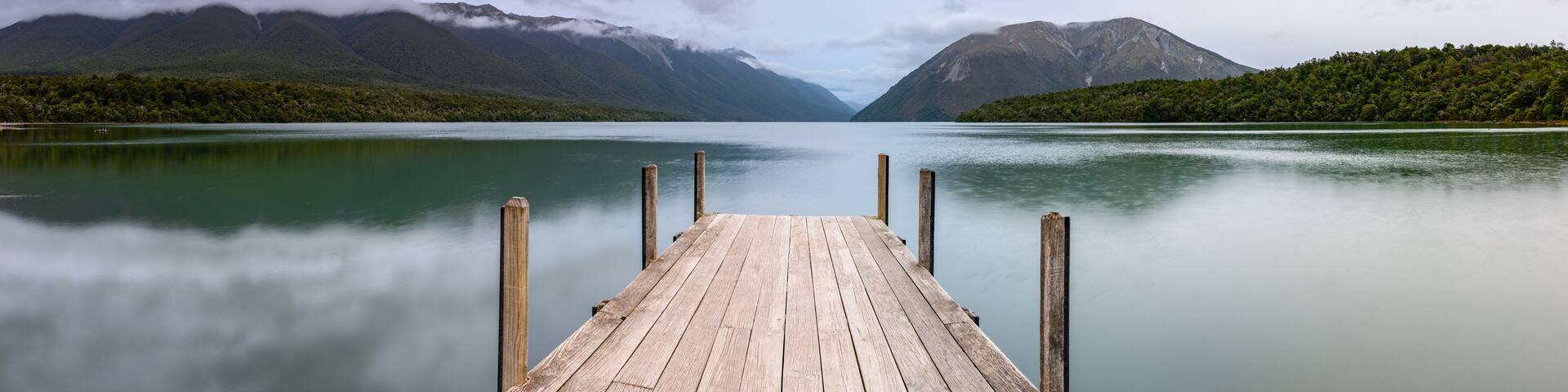 Landscape photo of a jetty on Lake Rotoiti, New Zealand. This jetty is within the Nelson Lakes National Park and is one of the most Instagrammed locations in New Zealand