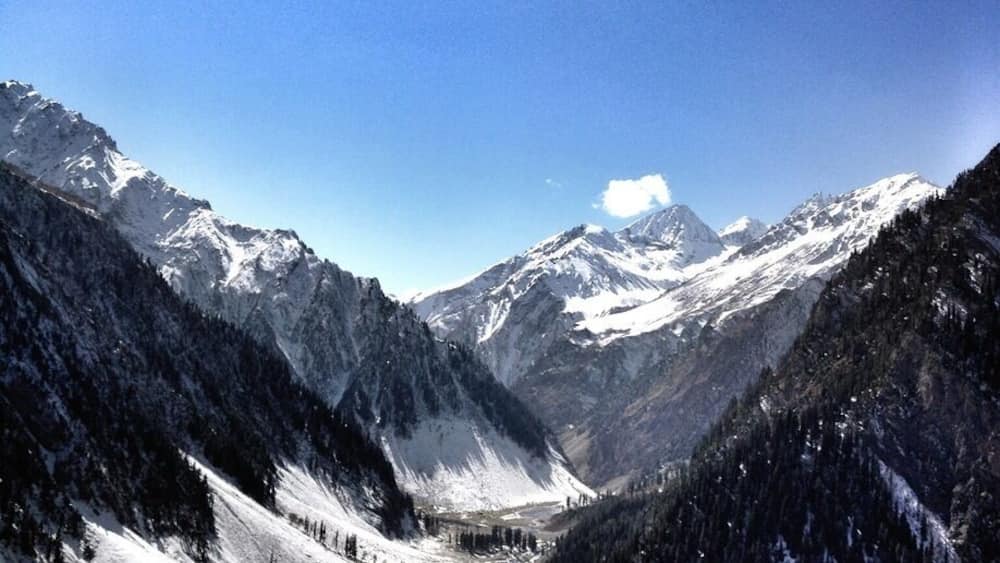 A snow-covered mountain range with a clear sky.