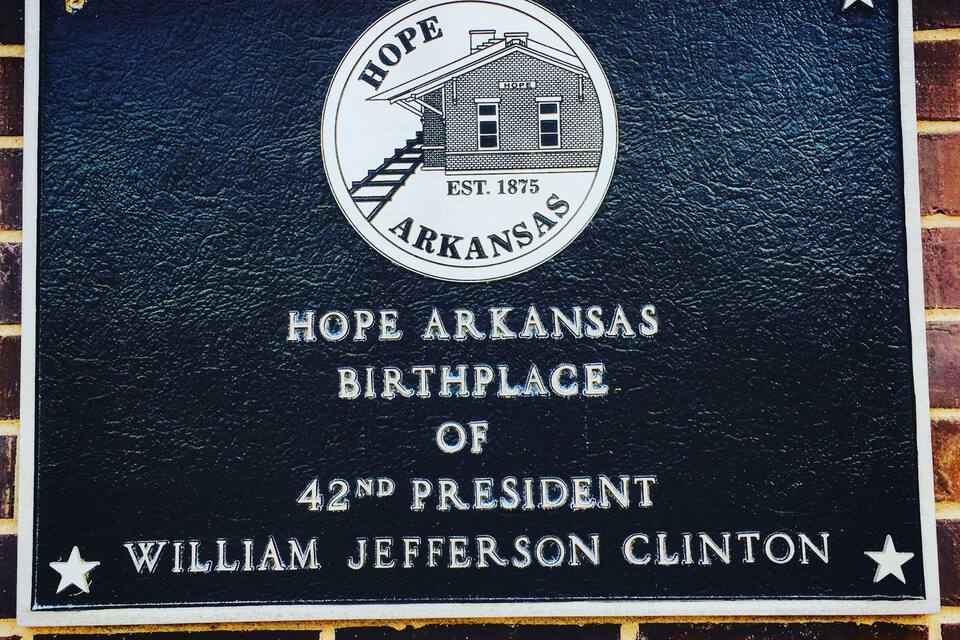 A historical plaque on a brick wall.