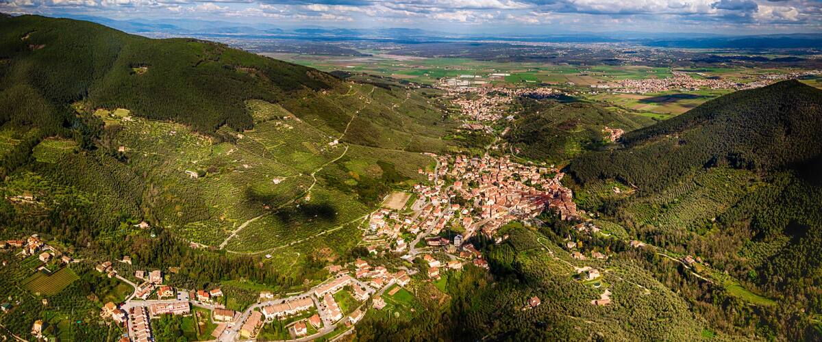 A mountainous landscape with a small town nestled in the valley.