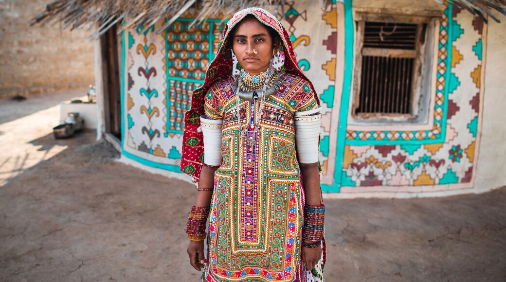 Ethnic Woman Near Traditional House