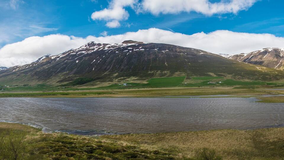A mountainous landscape with a lake and a river.