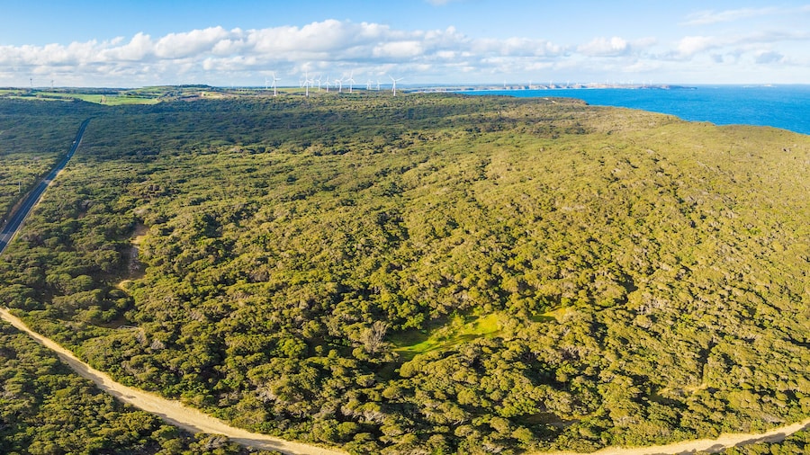 Aerial panorama of rural road passing through beautiful Australian countryside on bright spring day