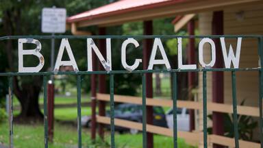 White Bangalow inscription on a weathered iron gate