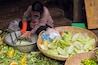 R4ABRG Woman grating green papaya for salad at Psar Chas Old Market in the centre of Siem Reap, the important north west tourist town, Siem Reap, Cambodia