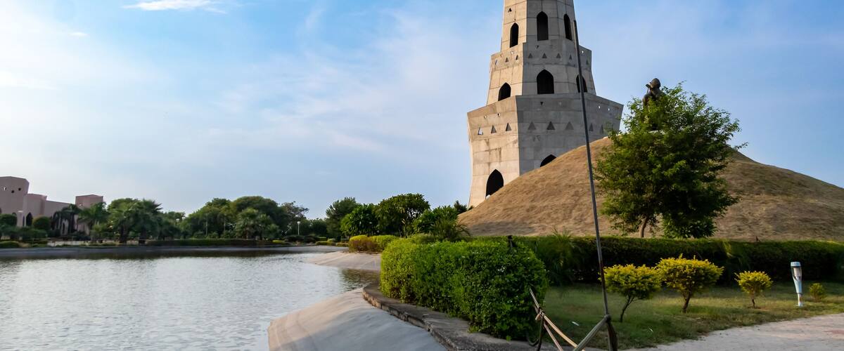 wide shot of fateh burj with lake against blue sky in the background. nature and out door concept.