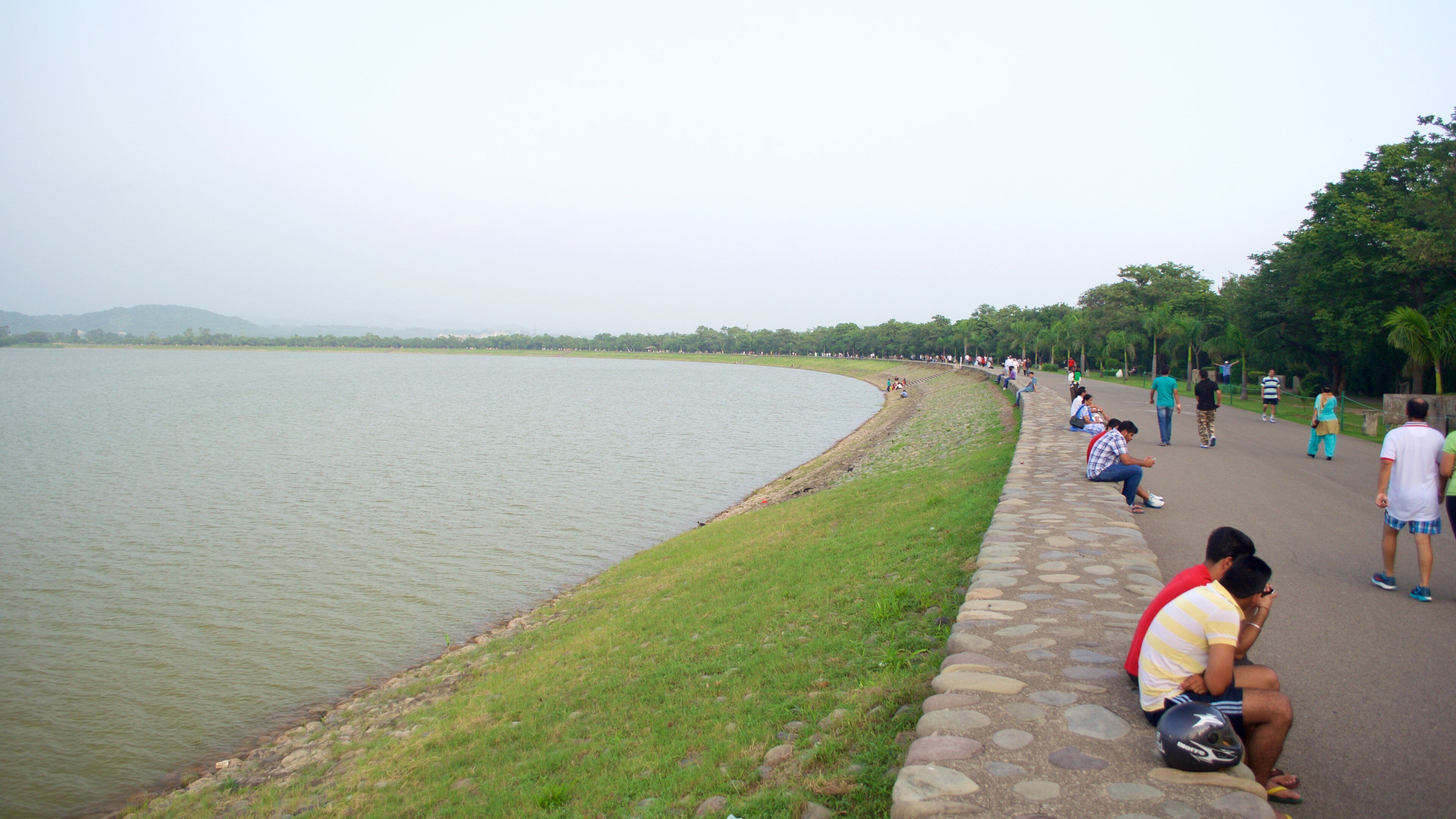 Chandigarh showing a lake or waterhole as well as a large group of people
