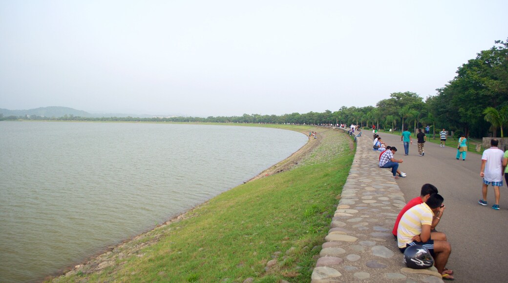 Chandigarh showing a lake or waterhole as well as a large group of people