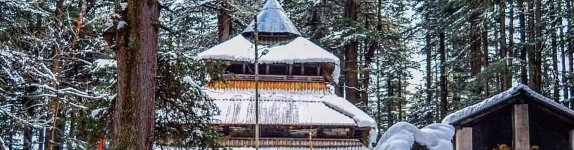 Located amidst the snow-covered hills of Manali, the Hadimba Temple is a unique shrine dedicated to Hidimba Devi, who was the wife of Bhima and mother of Ghatothkach. Surrounded by gorgeous cedar forests, this beautiful shrine is built on a rock which is believed to be in the image of goddess Hidimba herself. The construction style of the Hidimba Devi temple is entirely different from that of any of the other temples, with its wooden doorways, walls, and cone-shaped roof. This temple is a fitting dedication to its presiding deity Hadimba.
The magnificent Hidimba Devi Temple holds monumental importance to Hindu pilgrims as it is a part of the Hindu epic Mahabharata. Even apart from that, the Hadimba Temple is no less of wonder to nature lovers. Packed away into the laps of nature, this temple offers a quiet getaway to nature and peace lovers. Being quite a quaint story in itself, the Hidimba Temple is slowly but steadily attracting tourists from all over the country to its doors where history and heritage meet natural beauty.