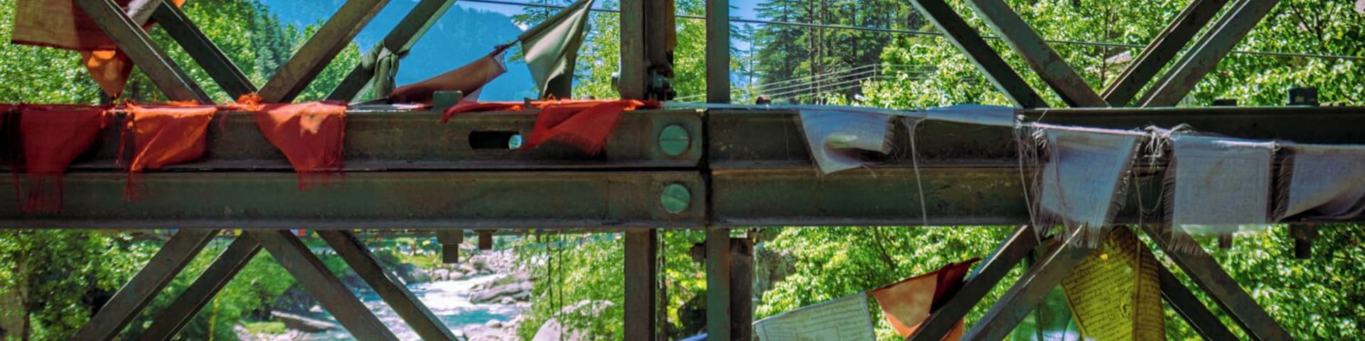 Prayer flags hanging from one of the bridges that connects New Manali with the highway going to Vashisht, in Northern India.