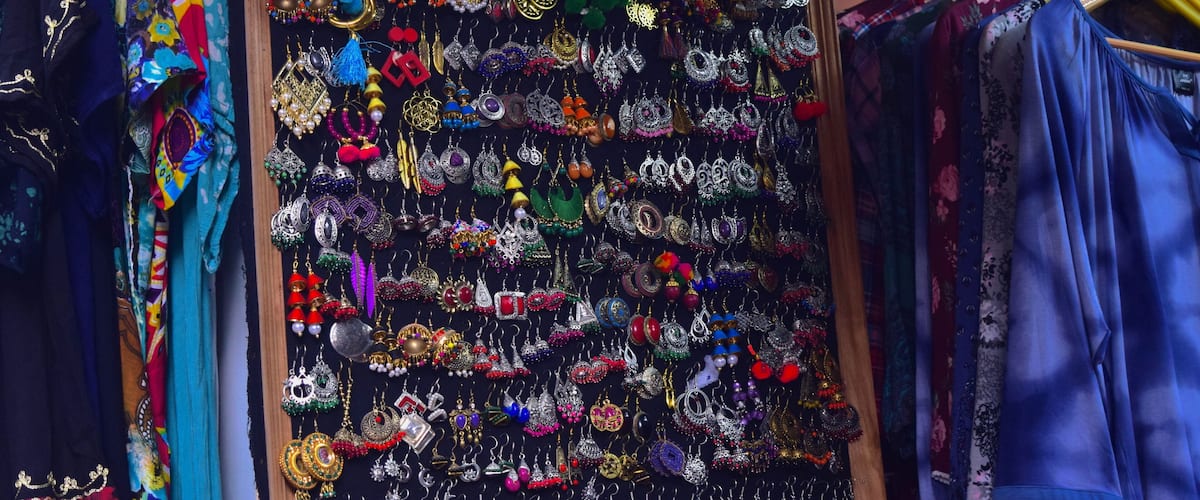 A display of colorful jewelry and clothing items in a shop.
