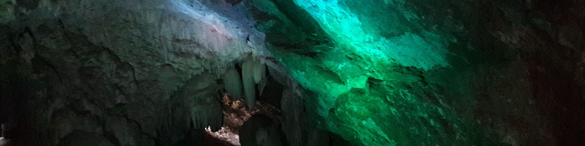 A cave with green and blue lighting.