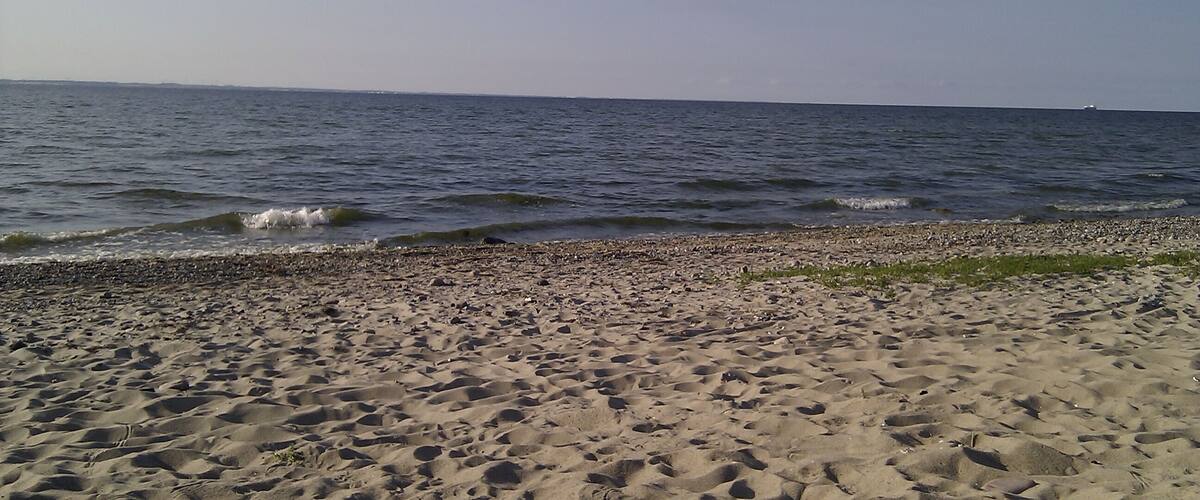 A beach with pebbles and waves.