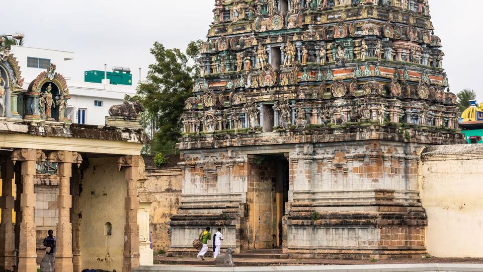 A large, intricately carved temple with multiple tiers and statues.