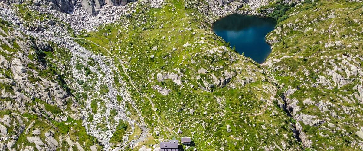 Aerial view of Denza refuge and the alpine Denza lake (Presanella lake) in the Adamello - Presanella group, Vermiglio in Trentino Alto Adige, northern Italy, Europe. Italian alps