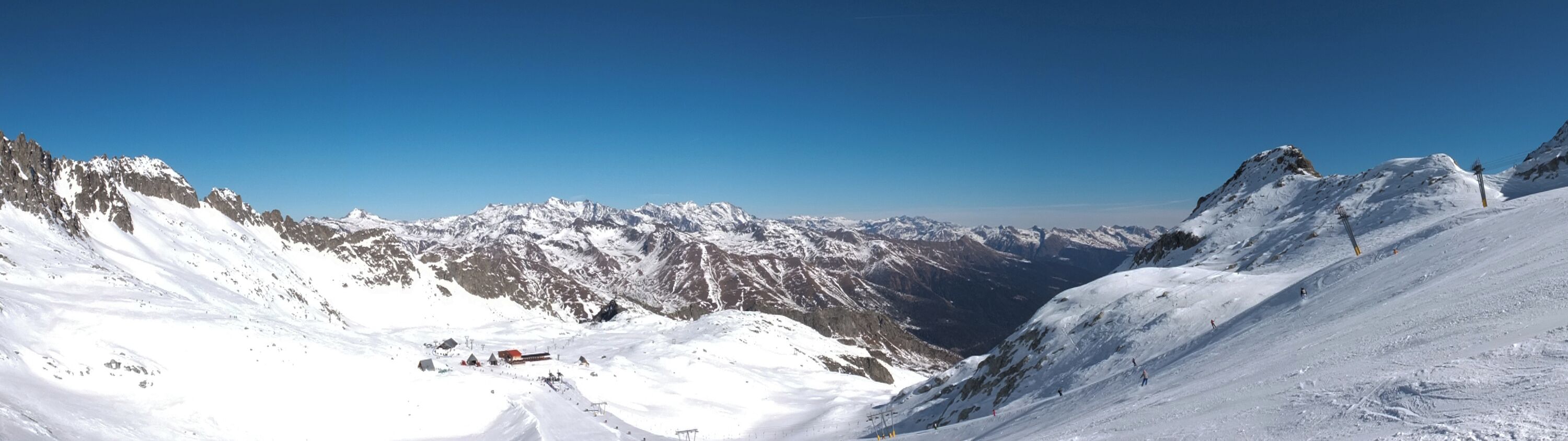 A snow-covered mountain range with clear skies.