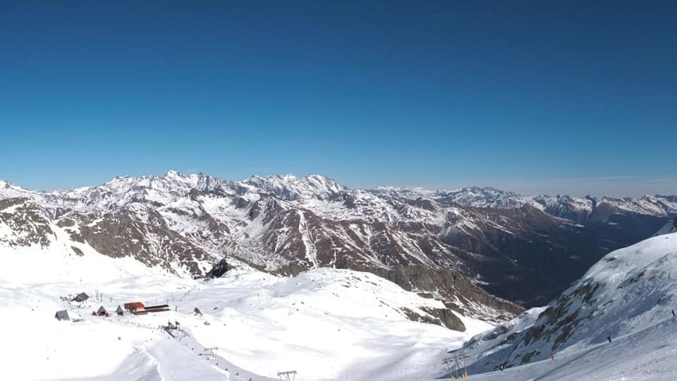 A snow-covered mountain range with clear skies.