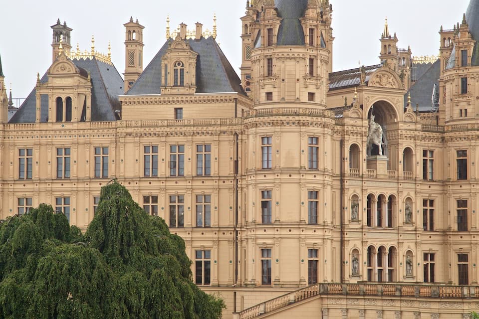 A grand, ornate building with multiple towers and statues.