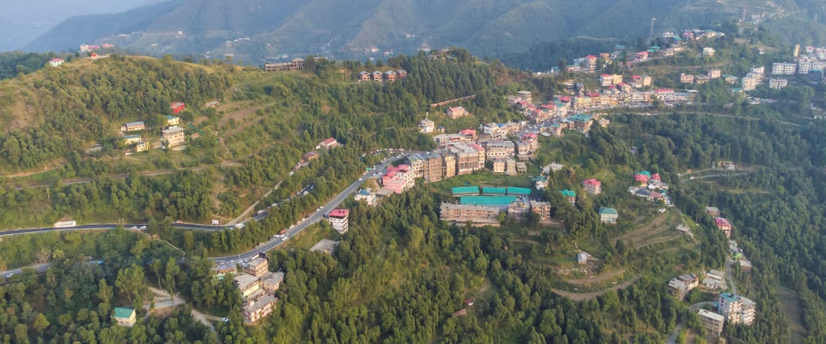 A mountainous town with buildings nestled among the hills.