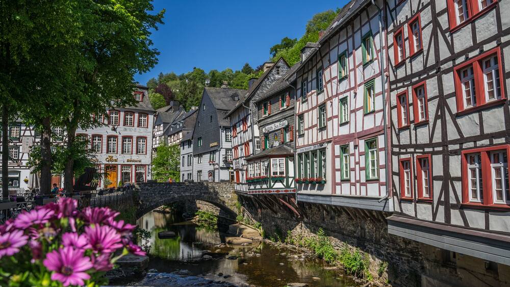 Monschau town in Germany street view with half-timbered houses and Rur river - a small resort town in the Eifel region of western Germany, located in the Aachen district of North Rhine-Westphalia