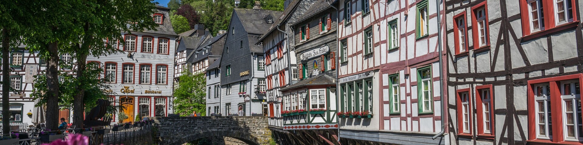 Monschau town in Germany street view with half-timbered houses and Rur river - a small resort town in the Eifel region of western Germany, located in the Aachen district of North Rhine-Westphalia