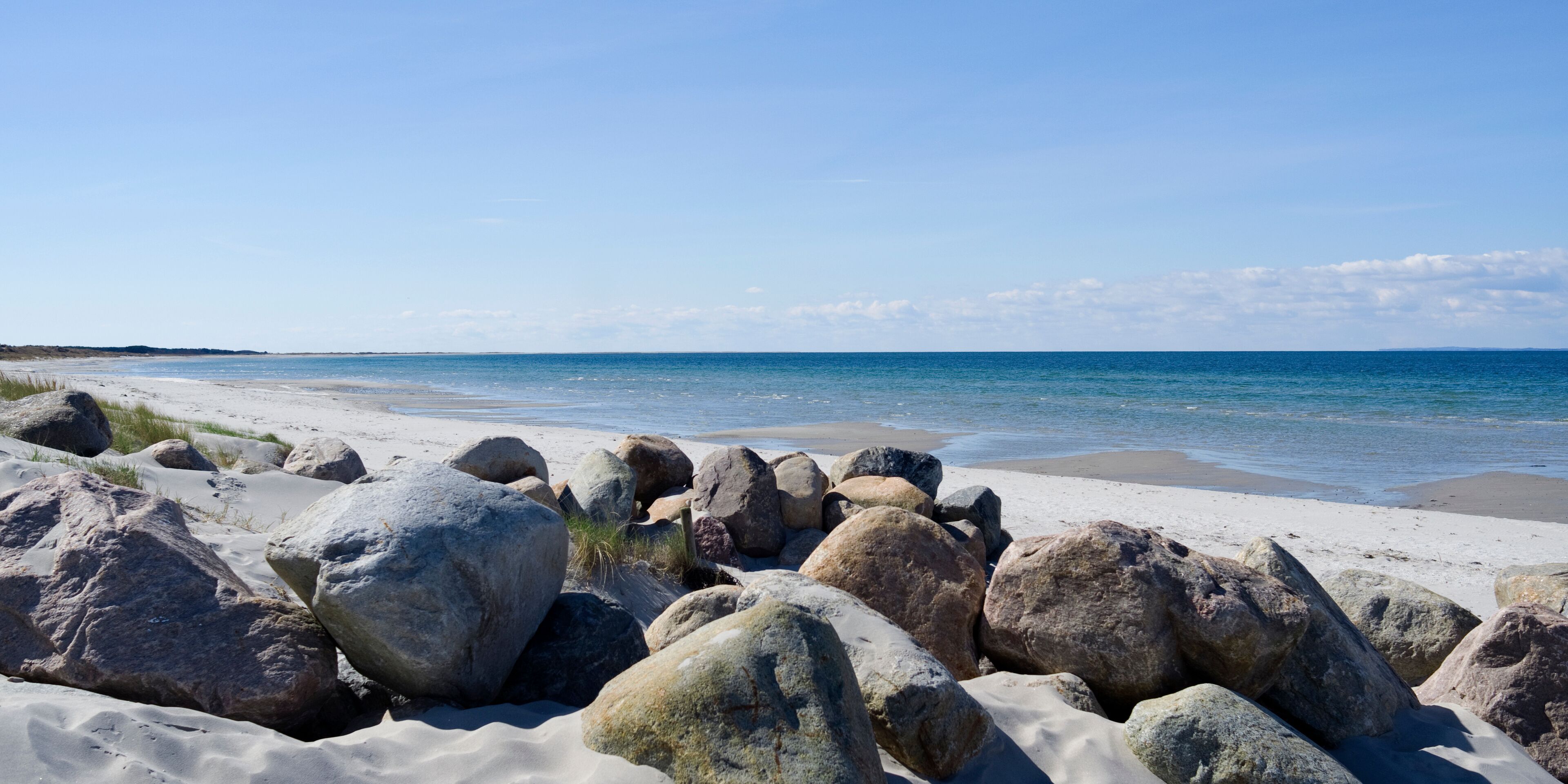 Laesoe / Denmark: Boulders at a beach access in Vesteroe Havn on a sunny day in April