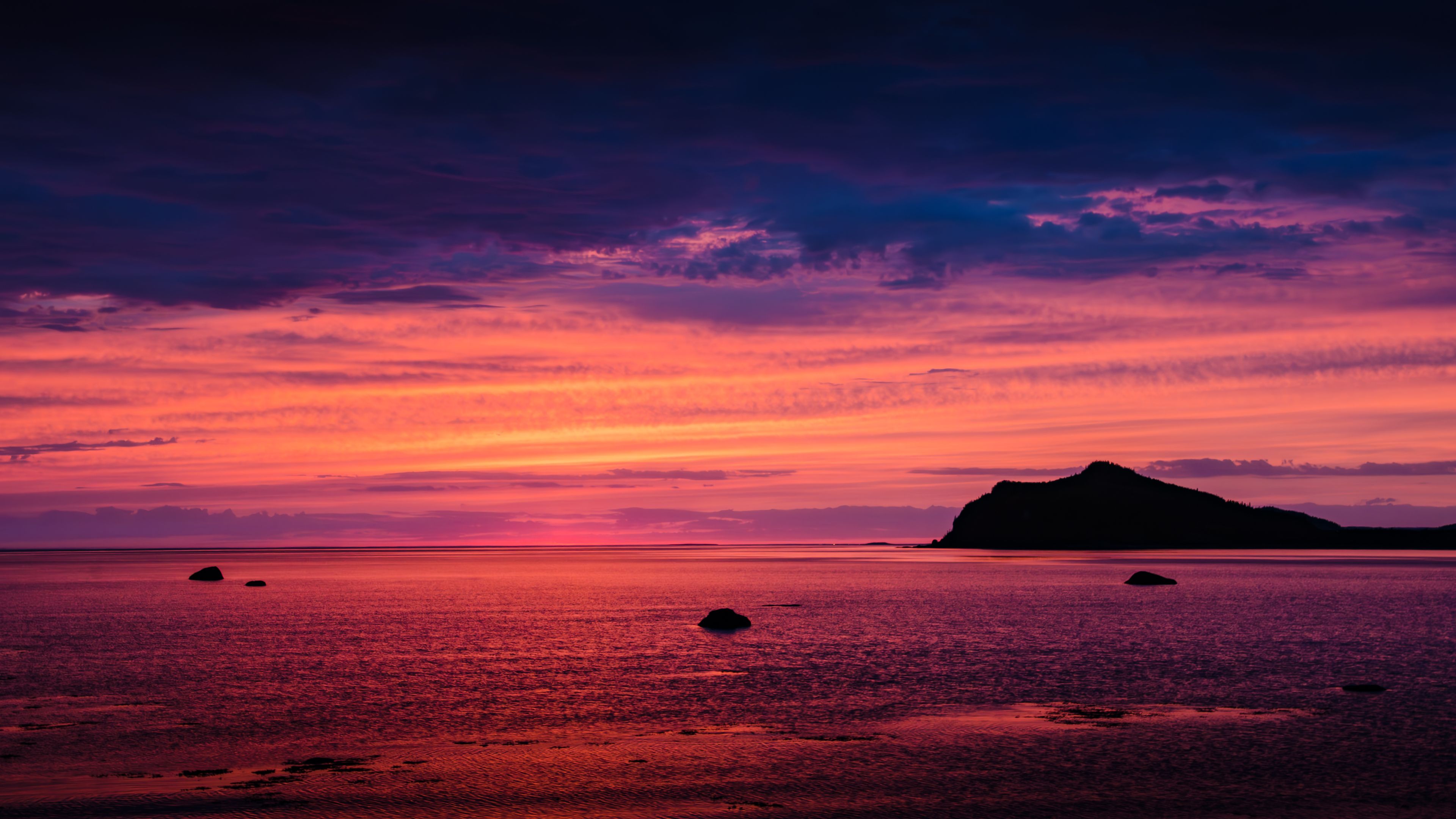 Panoramic view of the vibrant colors of the sunrise over the shores of Bic national park, Quebec, Canada