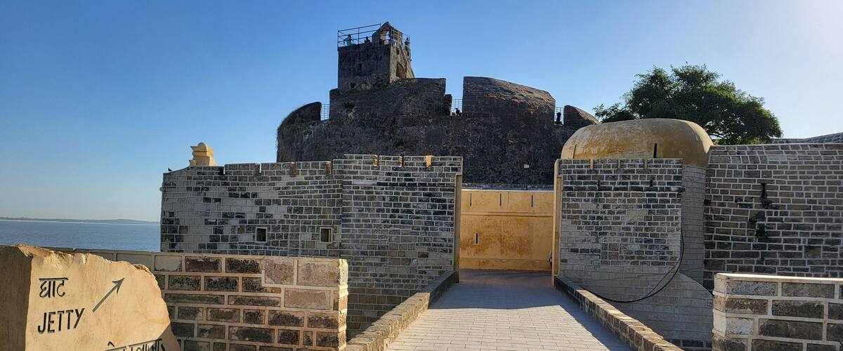 A historical fort with stone walls and a paved entrance.