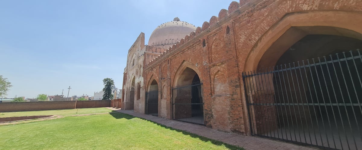 A historic building with arched gateways and a dome.