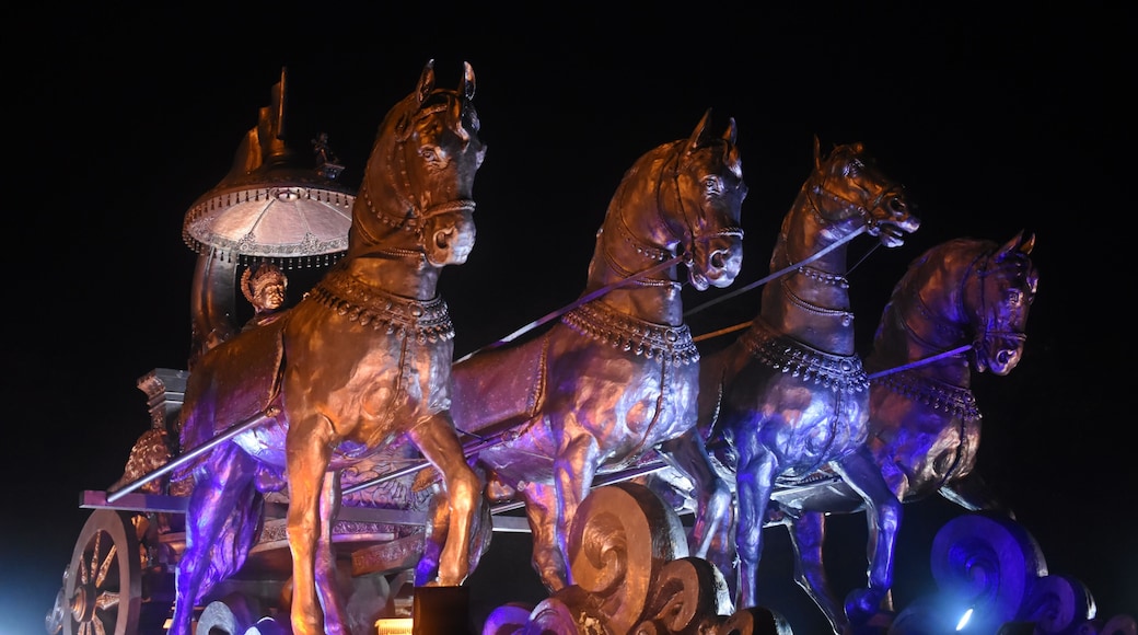 "Illuminated Bronze Chariot Statue of Krishna and Arjuna at Night in Kurukshetra, Haryana, India"