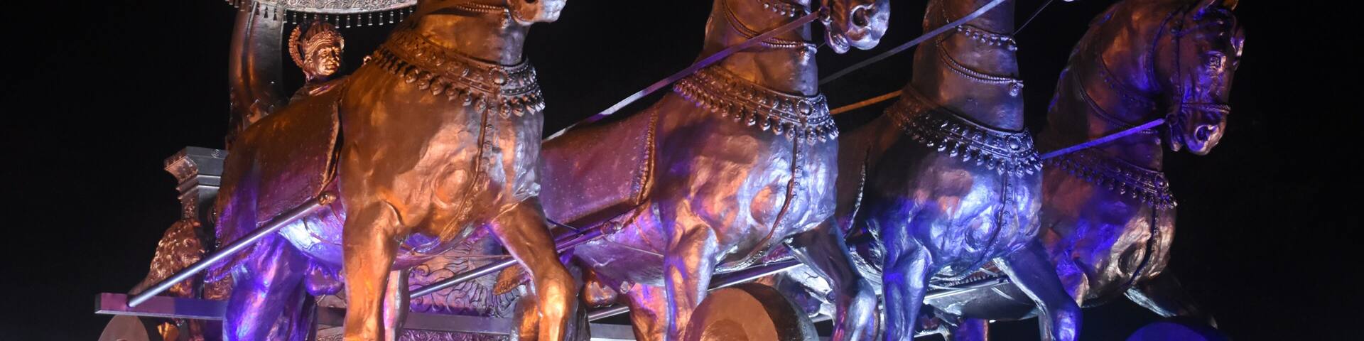 "Illuminated Bronze Chariot Statue of Krishna and Arjuna at Night in Kurukshetra, Haryana, India"
