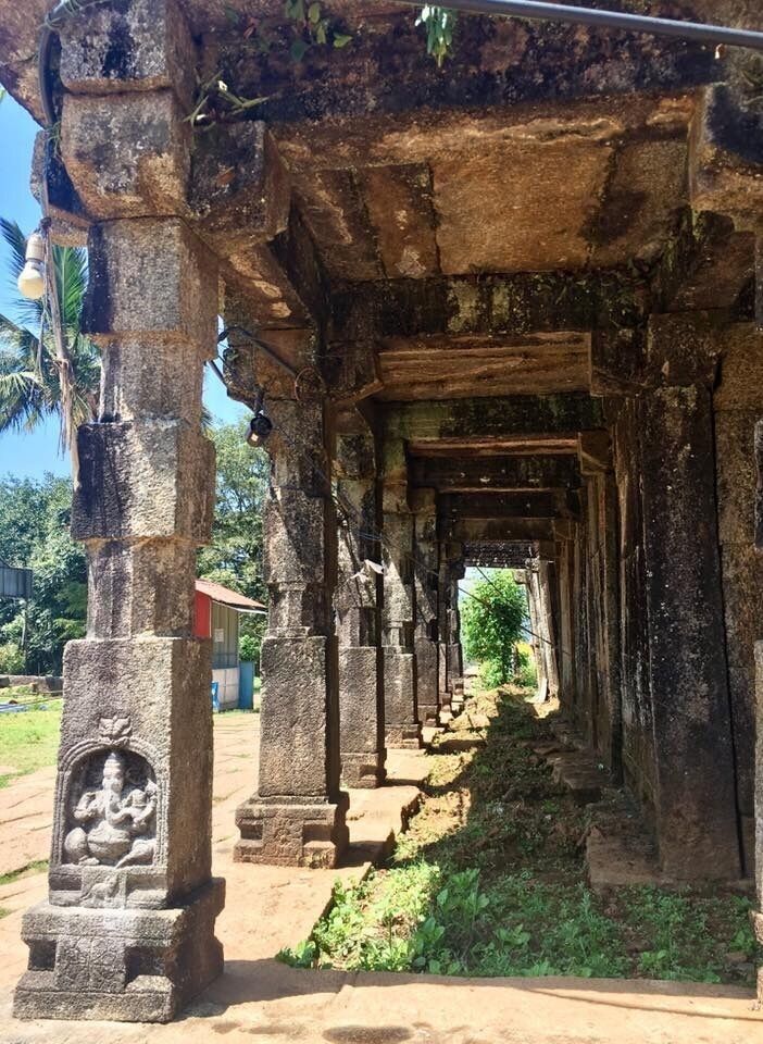 An ancient stone structure with a series of pillars and a central passageway.