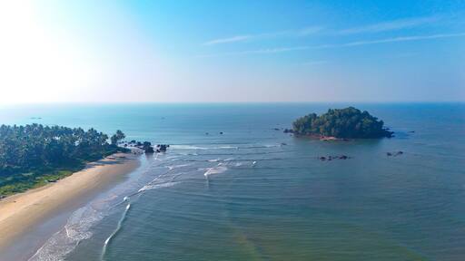 Breathtaking aerial view of Dharmadam Island, a private island covered in coconut trees located off the coast of Thalassery in Kannur, Kerala.