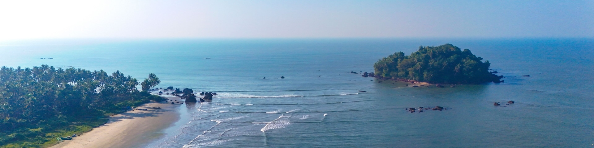 Breathtaking aerial view of Dharmadam Island, a private island covered in coconut trees located off the coast of Thalassery in Kannur, Kerala.
