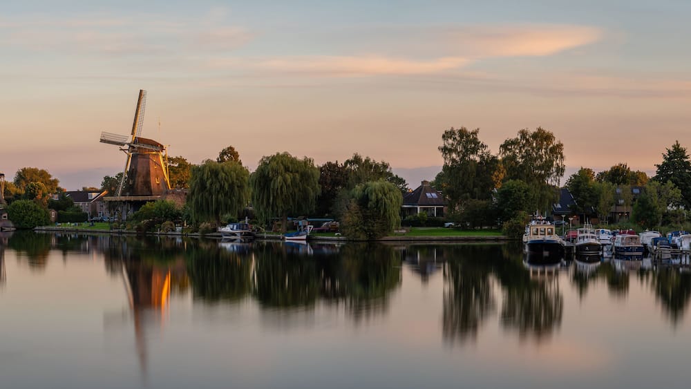 Panorama of Weesp, view of the historical windmills along the river Vecht in the evening
