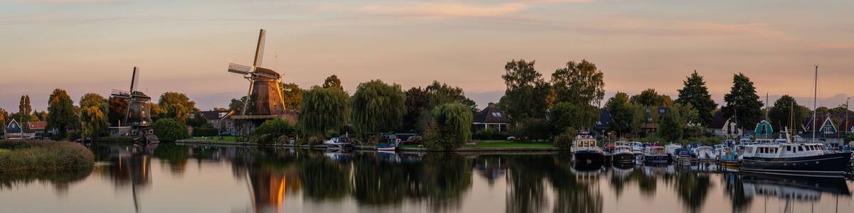 Panorama of Weesp, view of the historical windmills along the river Vecht in the evening